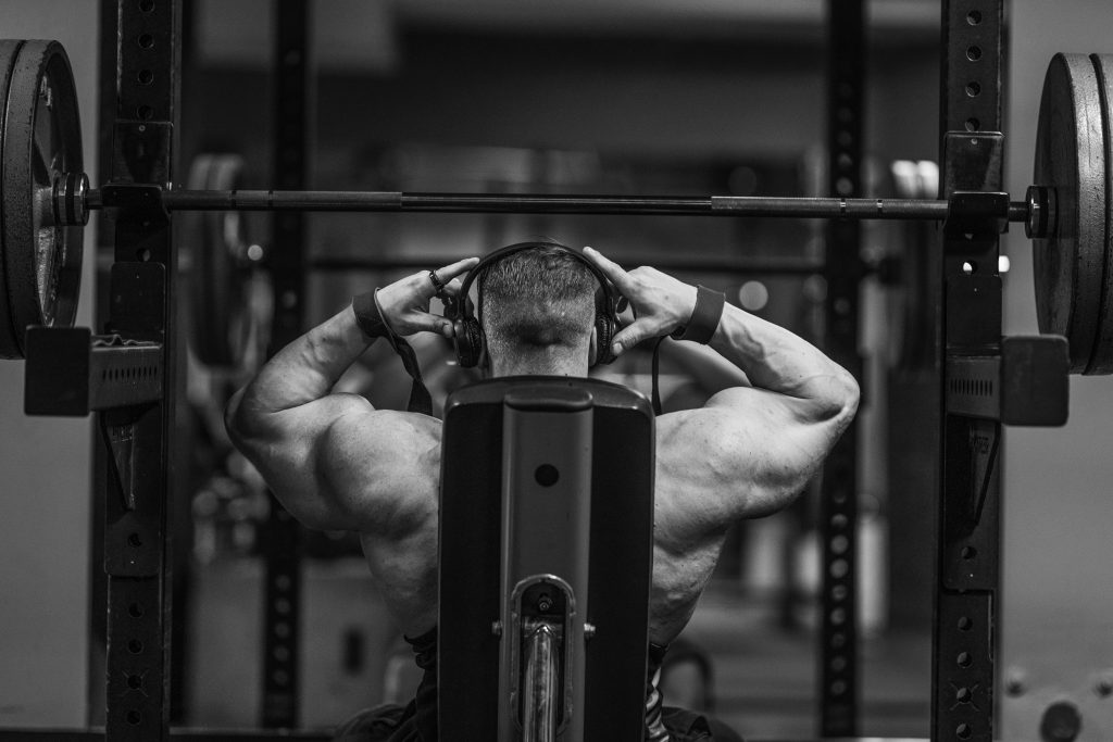 pexels-photo-15046713-15046713 Muscular man lifting weights in a gym setting, showcasing strength and fitness.